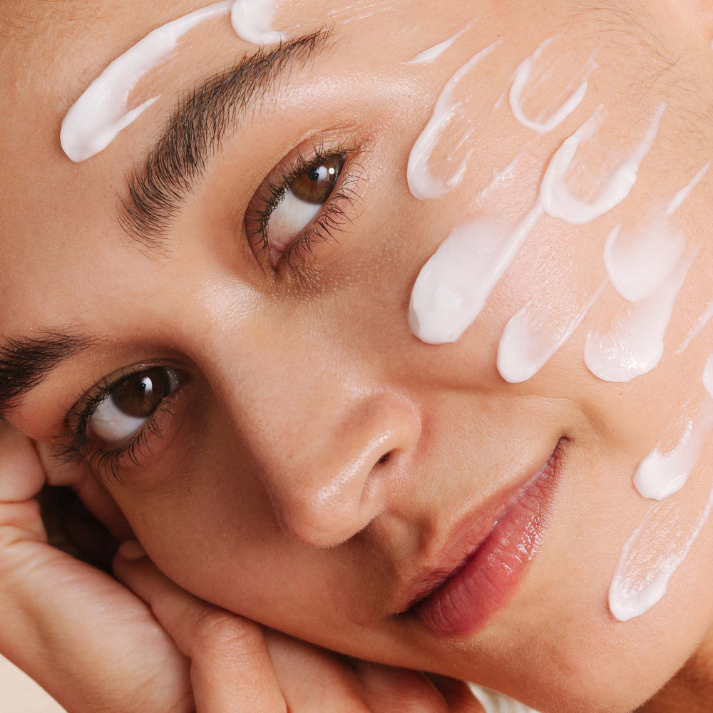 Close-up of a woman's face with hydrating lotion applied to her skin