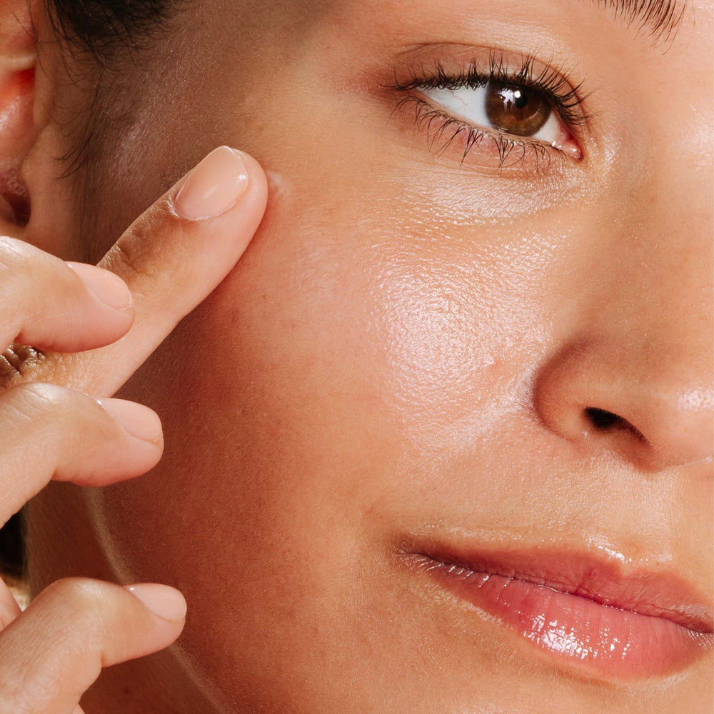 Close-up of a person applying makeup to their face
