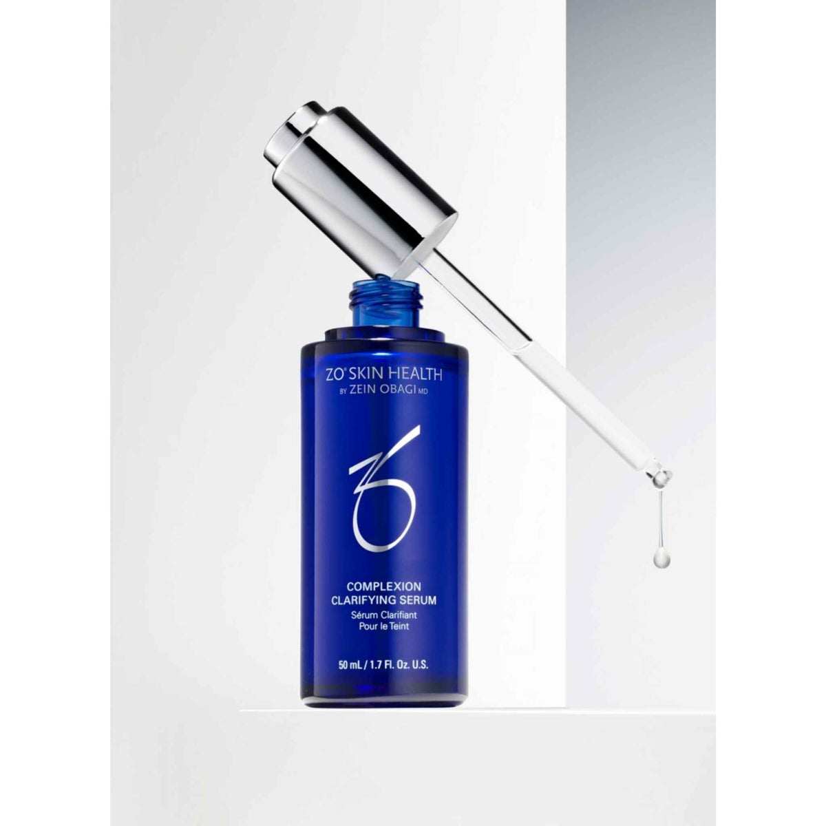 ZO Skin Health by Zein Obagi Complexion Clarifying Serum 50mL in a dark blue bottle with a silver dropper cap, shown with the glass dropper resting against the bottle on a white background.