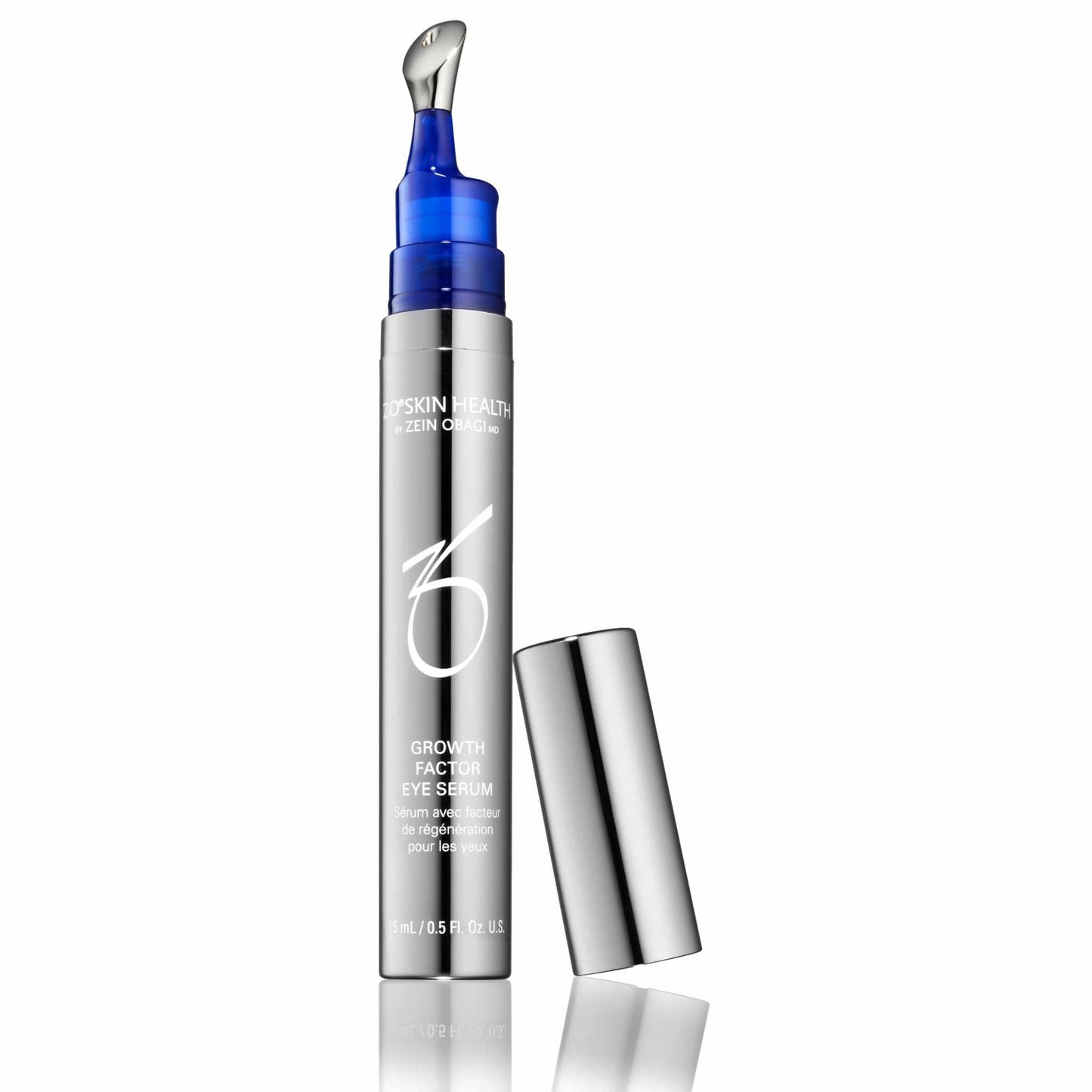 A silver cylindrical bottle of ZO Skin Health Growth Factor Eyes Serum with a blue pump and applicator tip, shown with its metallic cap standing beside it on a white background.