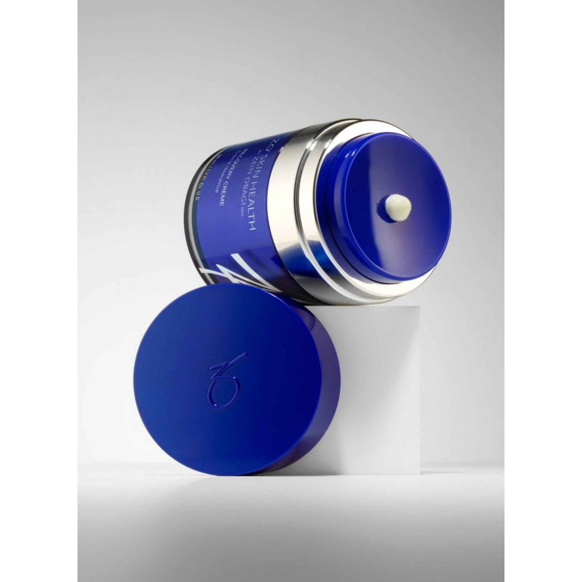 ZO Skin Health Recovery Creme 50mL bottle with open lid laying on its side
The Facial Maestro