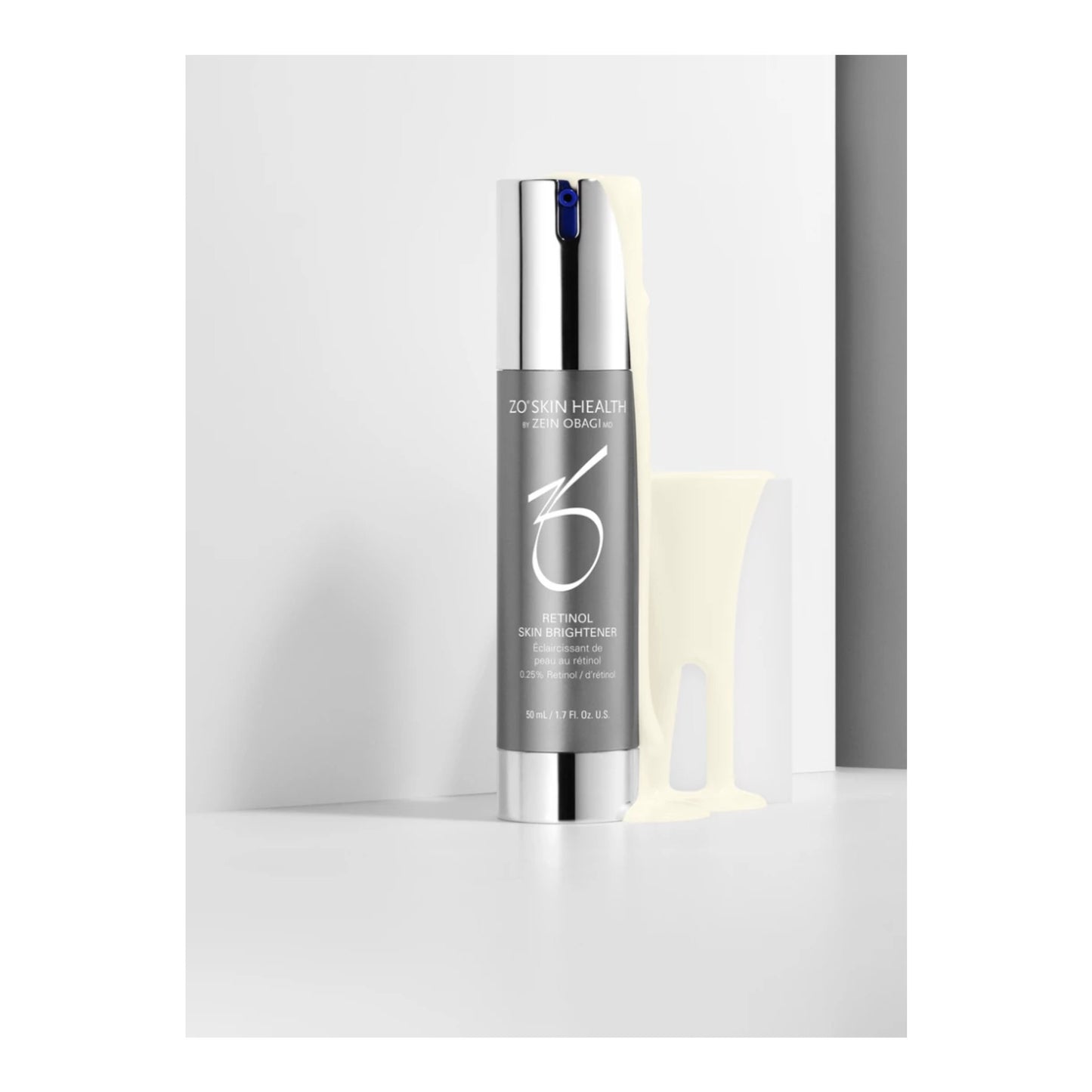 A bottle of ZO Skin Health Retinol Skin Brightener with a reflective silver cap and dark gray label, standing next to a translucent pale yellow applicator on a light gray background.