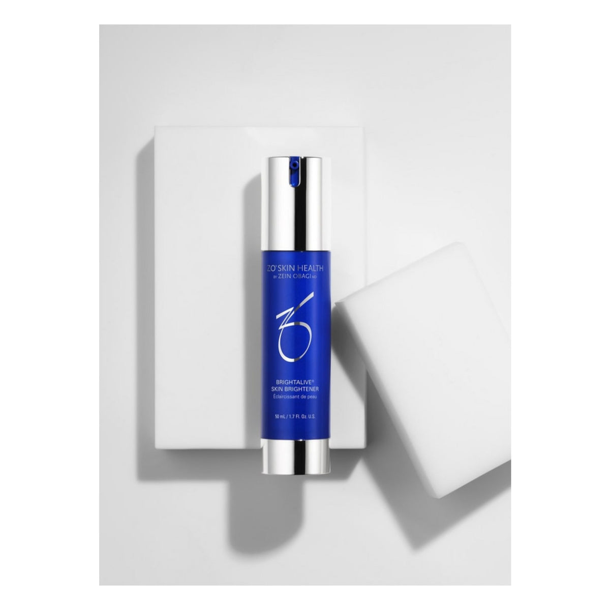 ZO Skin Health Brightalive Skin Brightener 50mL displayed on a white rectangular block with a white textured prop against a light gray background.