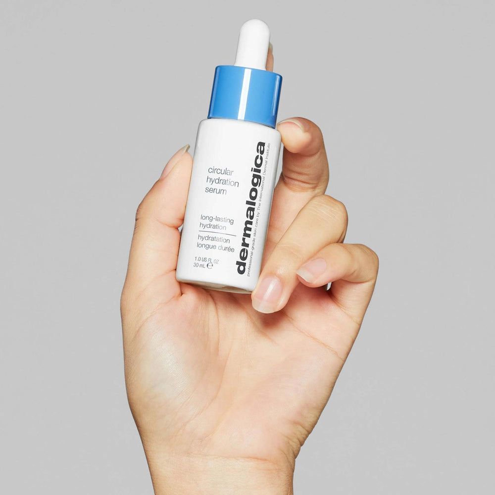 Hand holding a Dermalogica circular hydration serum bottle against a gray background
