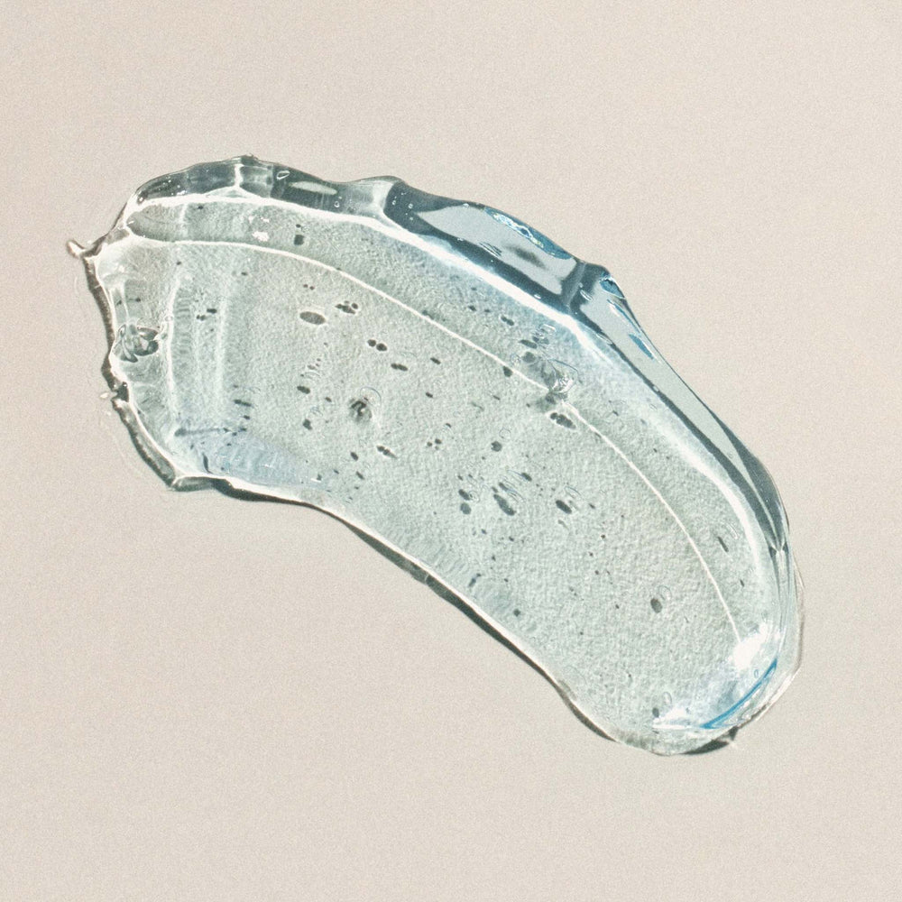 Swatch of aqua jelly product on a beige background