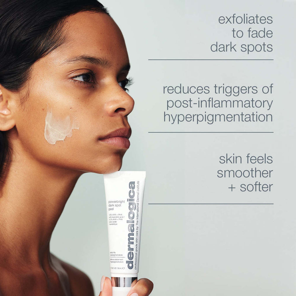 Woman holding a tube of dermalogica powerbright dark spot peel with text about skin benefits on a gray background